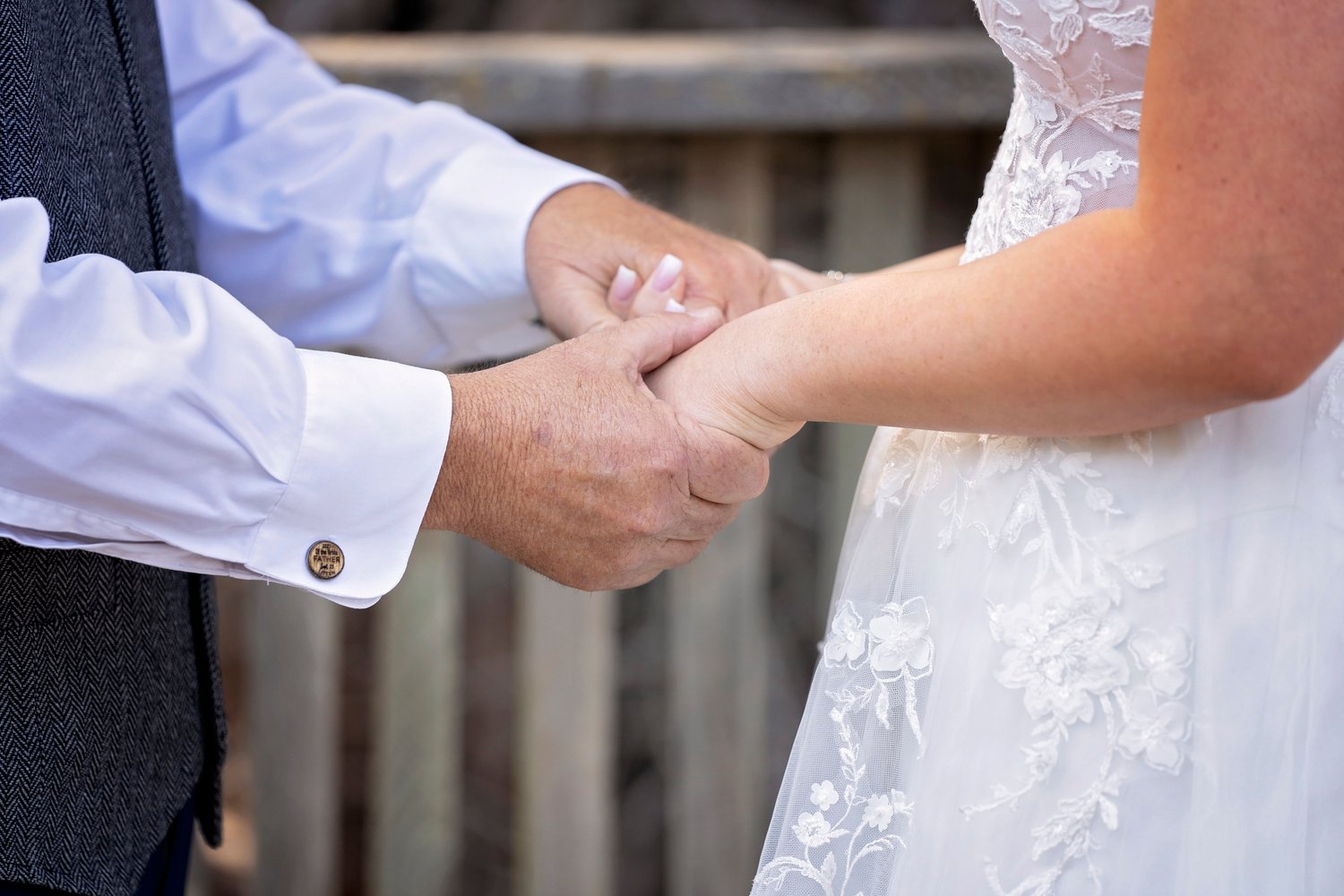 bride and her father hold hands