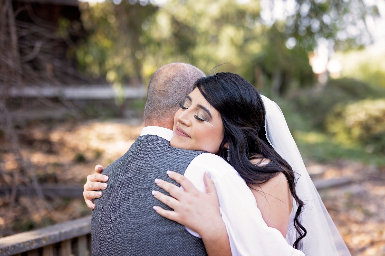 bride hugging her father during the first look