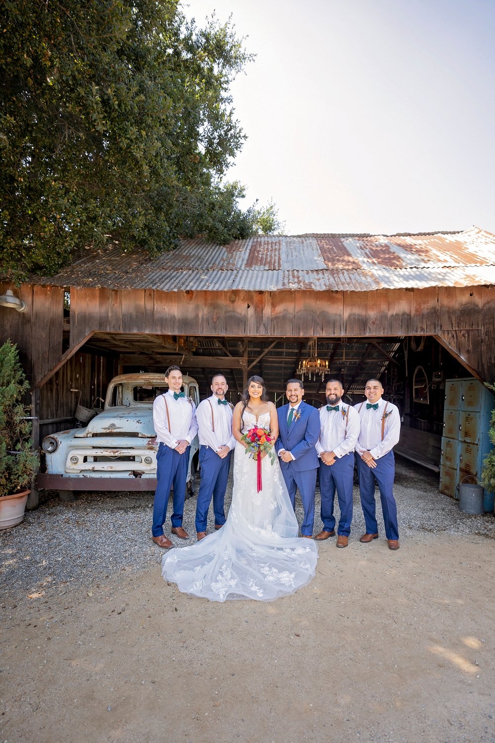 bride and groom standing with the groomsmen