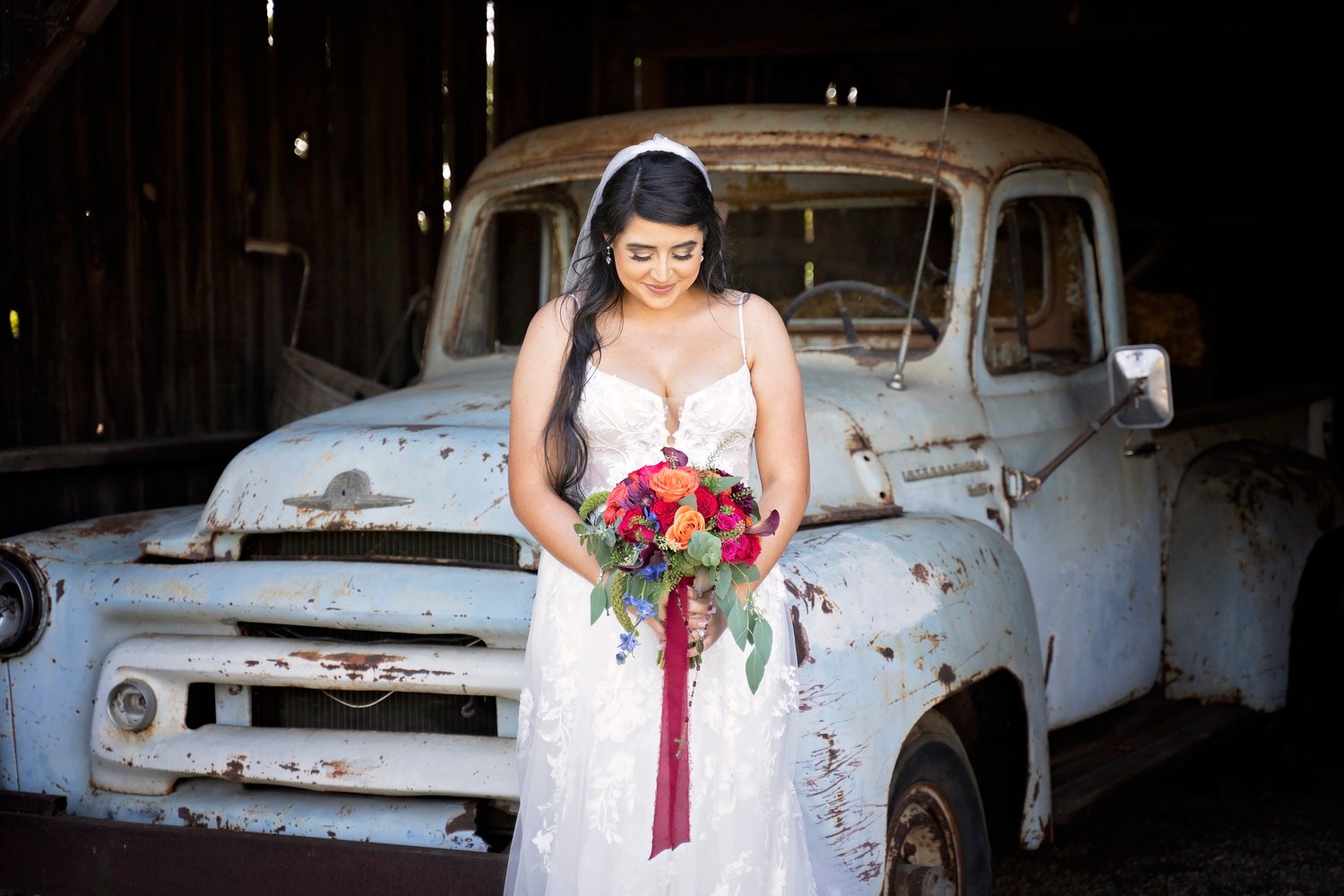 bride standing in front of a vintage truck at Dana Powers House