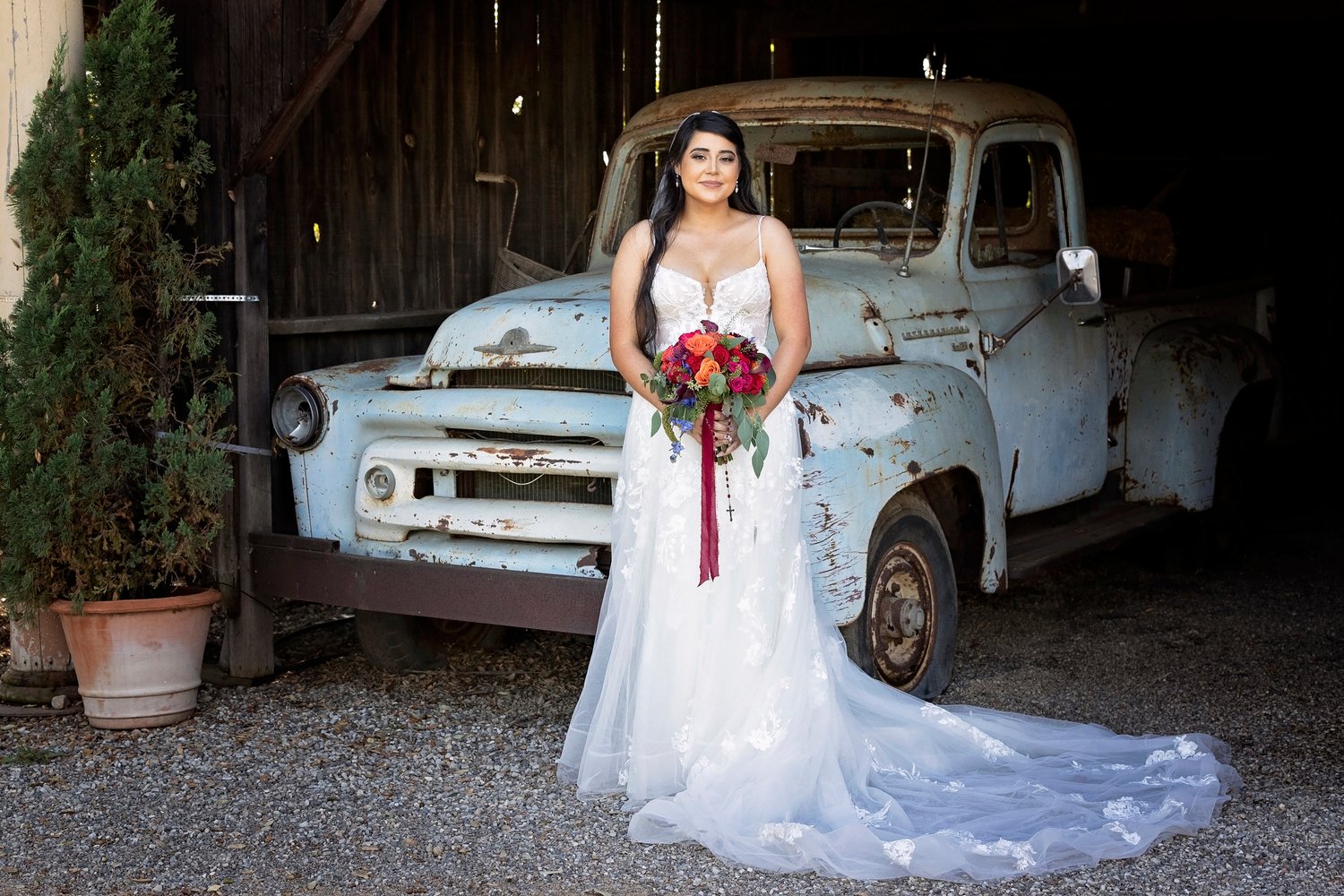 bride standing in front of a vintage truck at the Dana Powers House
