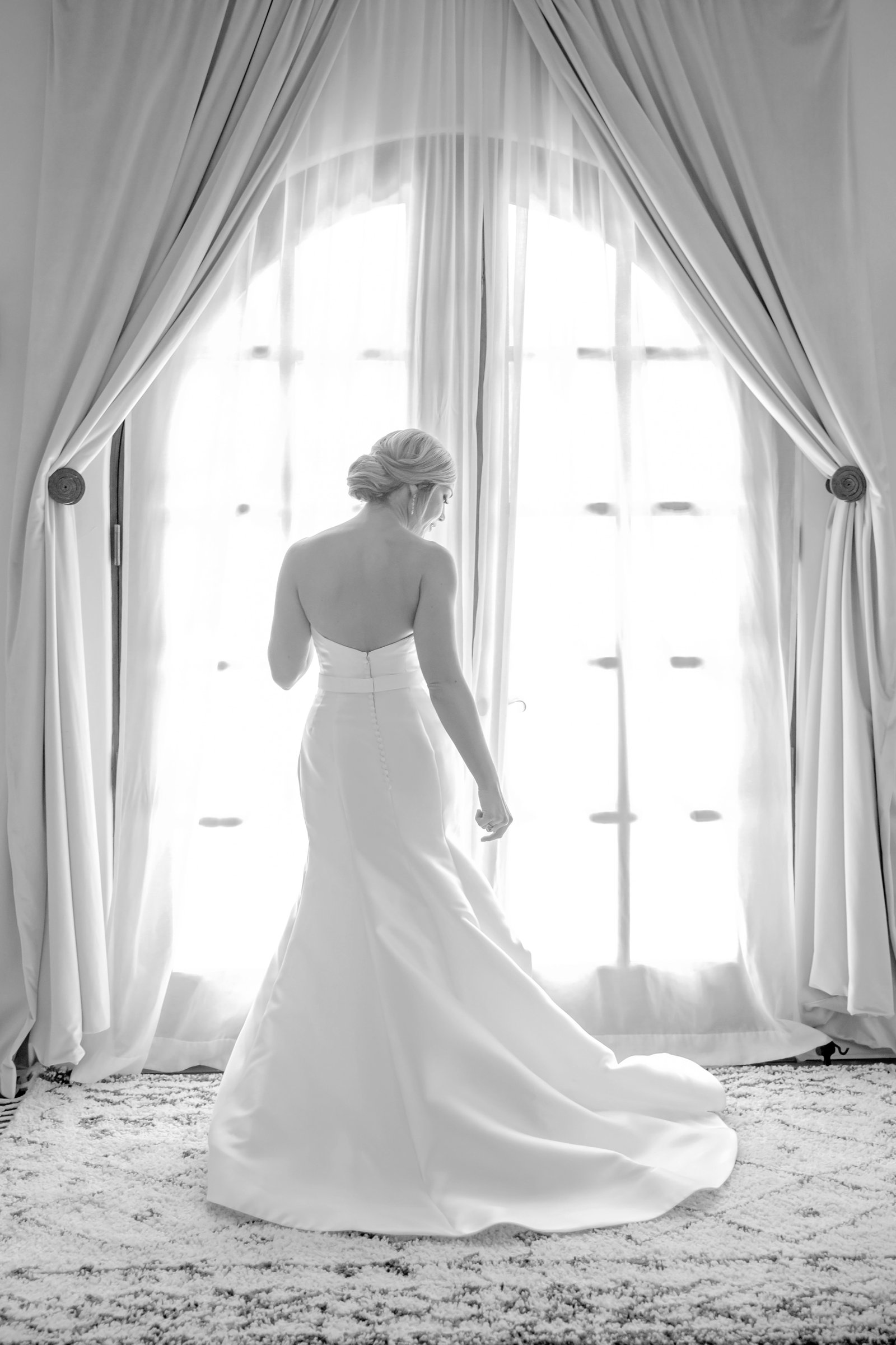bride in front of an arched french door