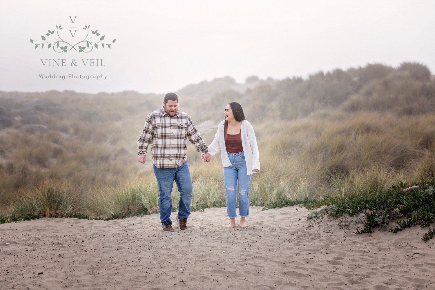 couple walking in the sand holding hands