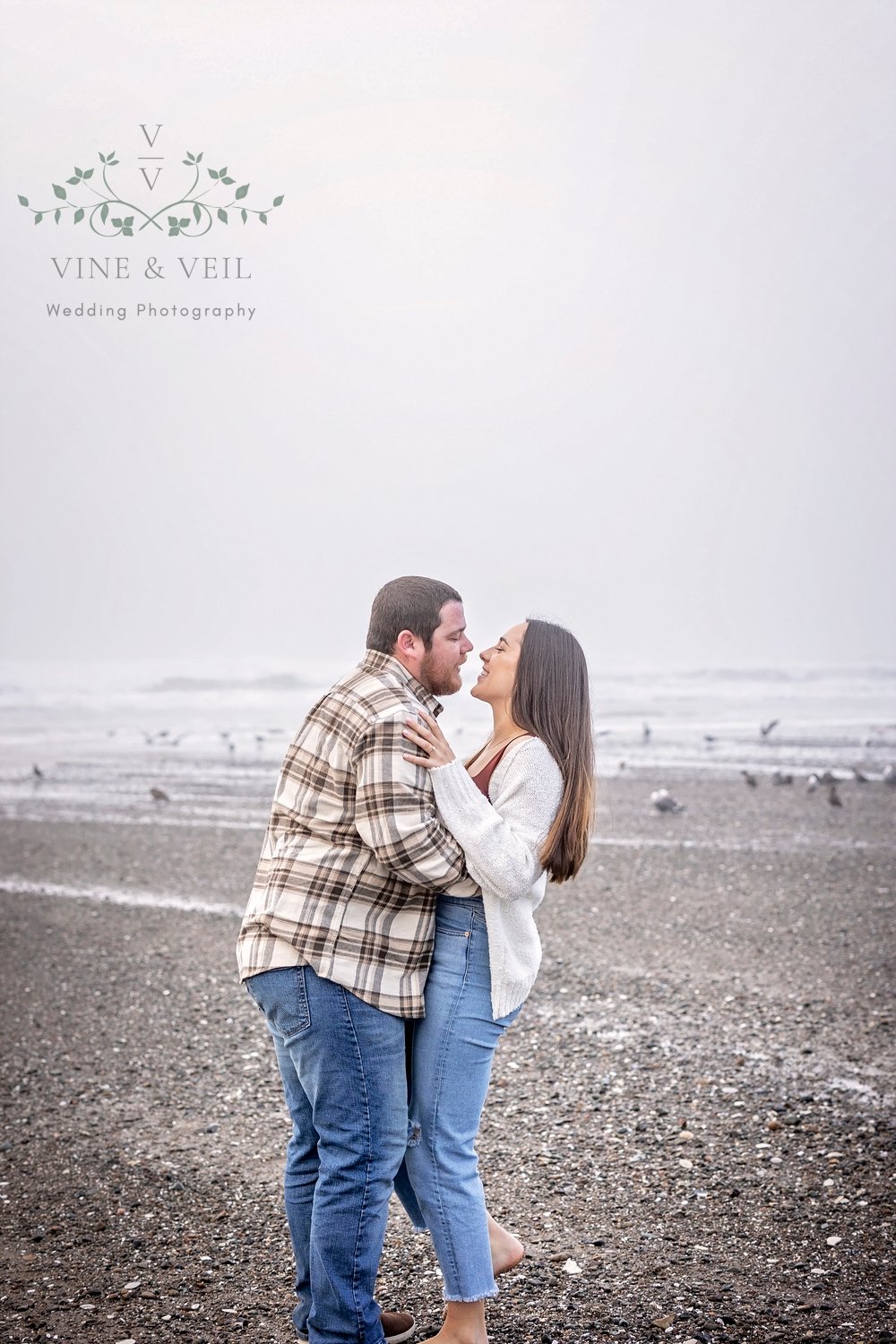 couple dancing at the beach during their engagement session