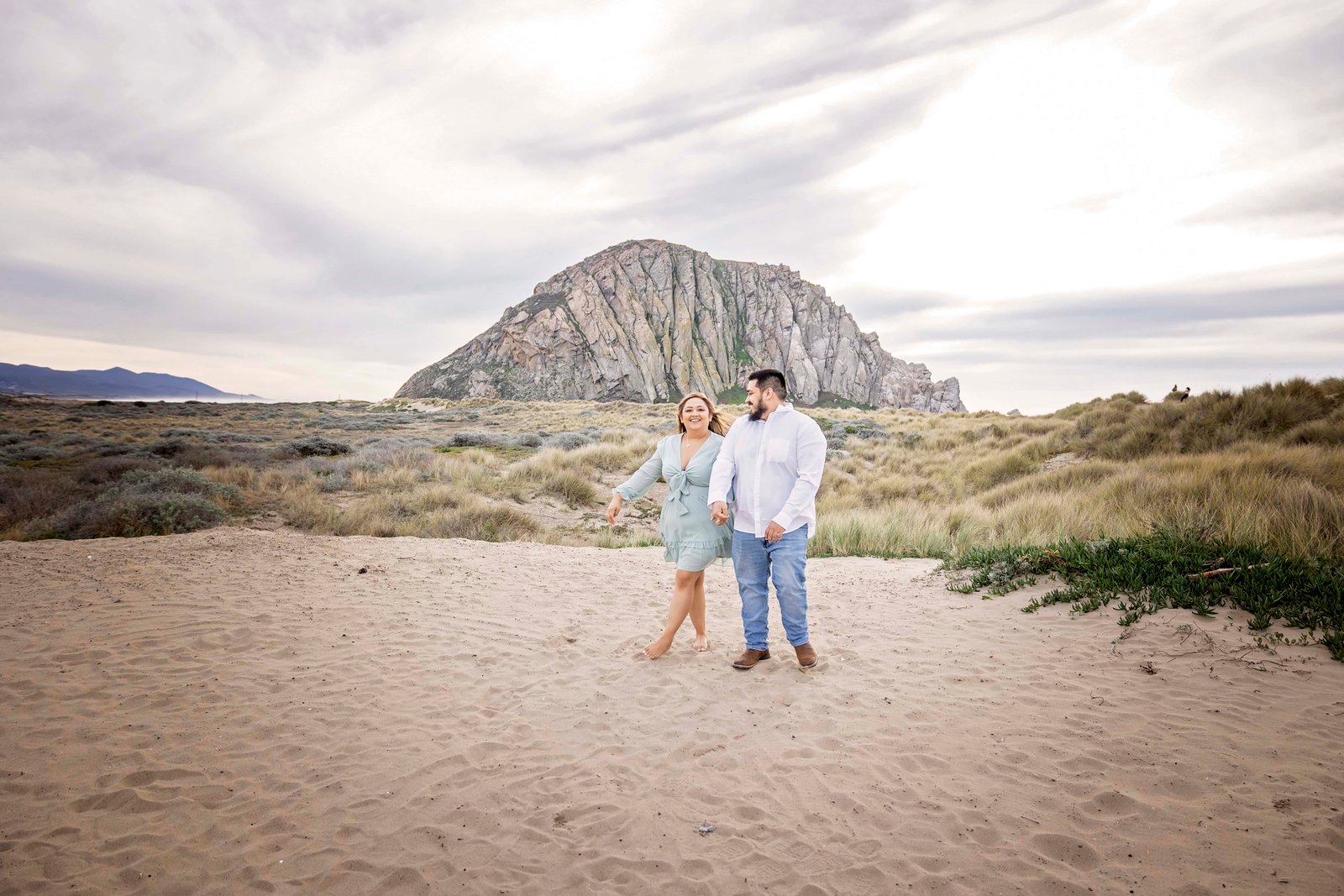 couple walking together in the sand at the Morro Bay dunes