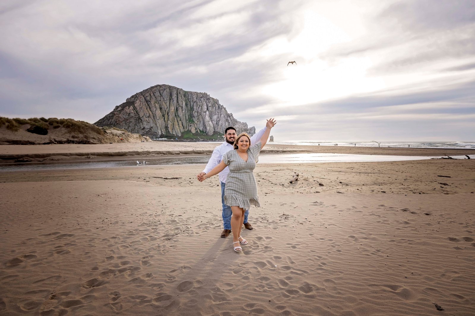 couple dancing together at sunset at Morro Rock